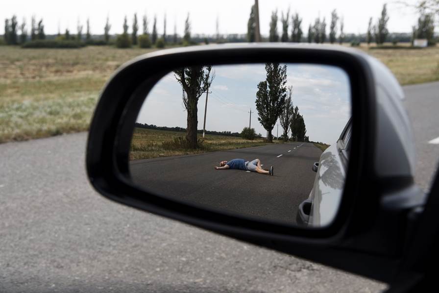 A person lying on the road in a side mirror

AI-generated content may be incorrect.